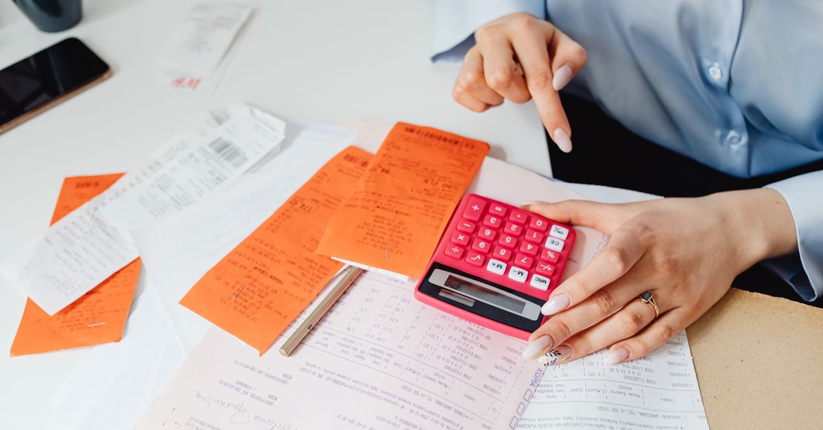 Businesswoman calculates expenses using receipts and calculator at desk. Ideal for finance, accounting themes. — illustrating gas receipt generator