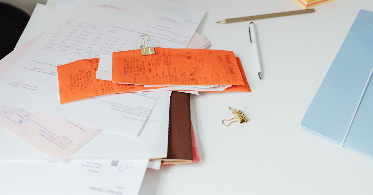 Close-up of a tidy desk with receipts, documents, and office stationery for business organization. — illustrating gas receipts