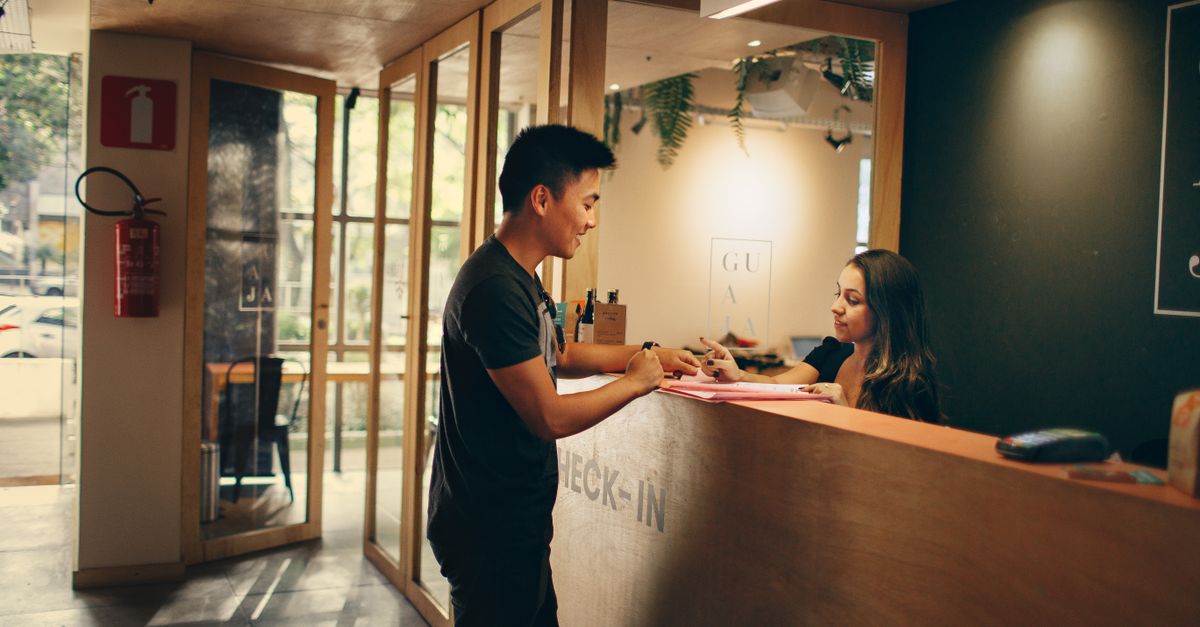 A customer checks in at a hotel reception desk in Belo Horizonte, Brazil. — illustrating hotel receipt