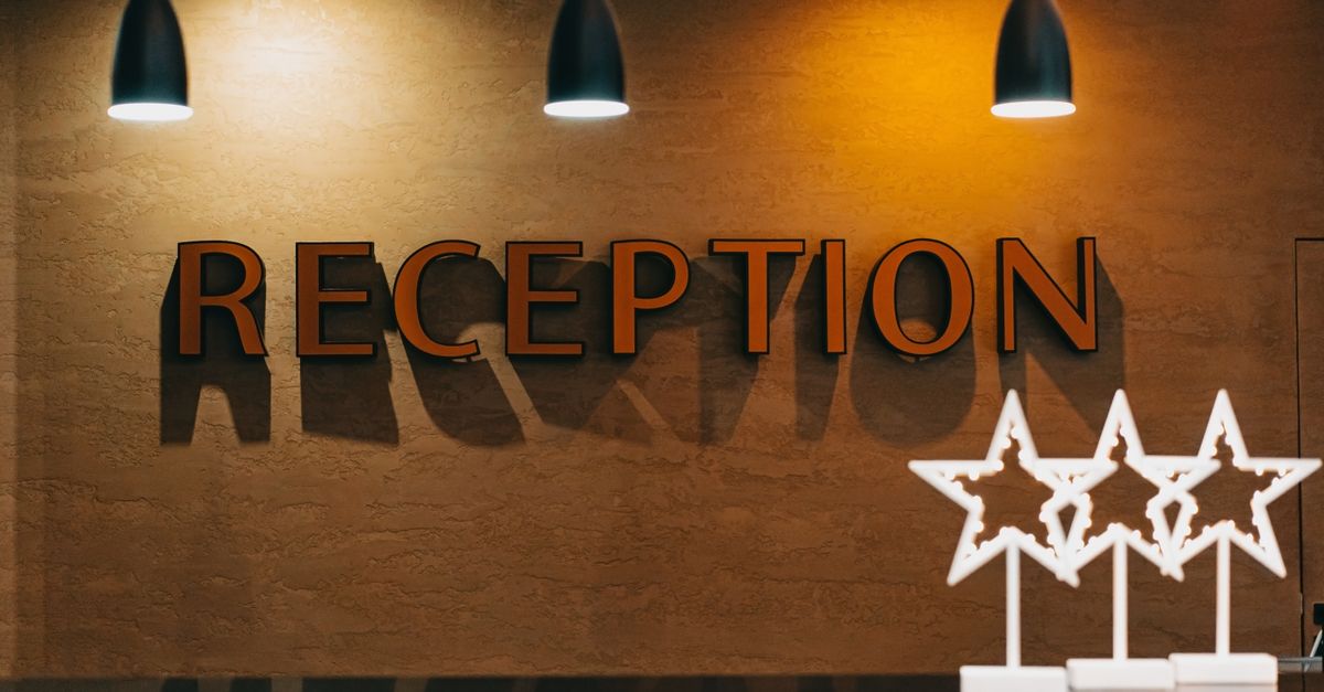 Elegant hotel reception area with illuminated signage and decor. — illustrating hotel receipt