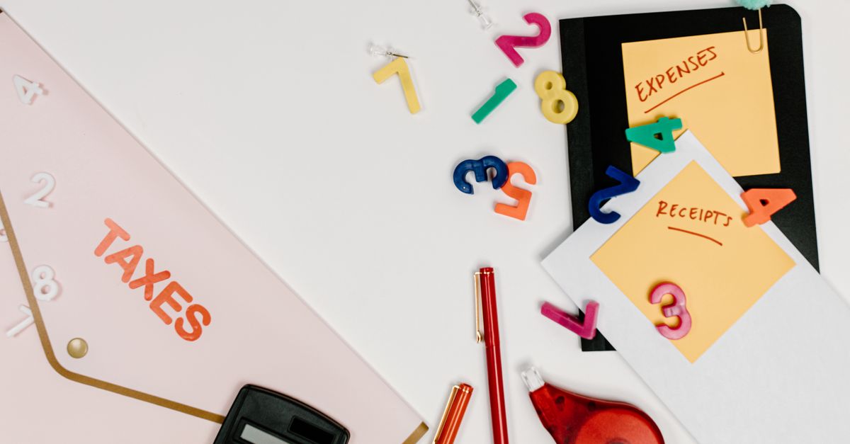Flat lay of tax documents, receipts, calculator, and colorful numbers for budgeting. — illustrating how to create a receipt