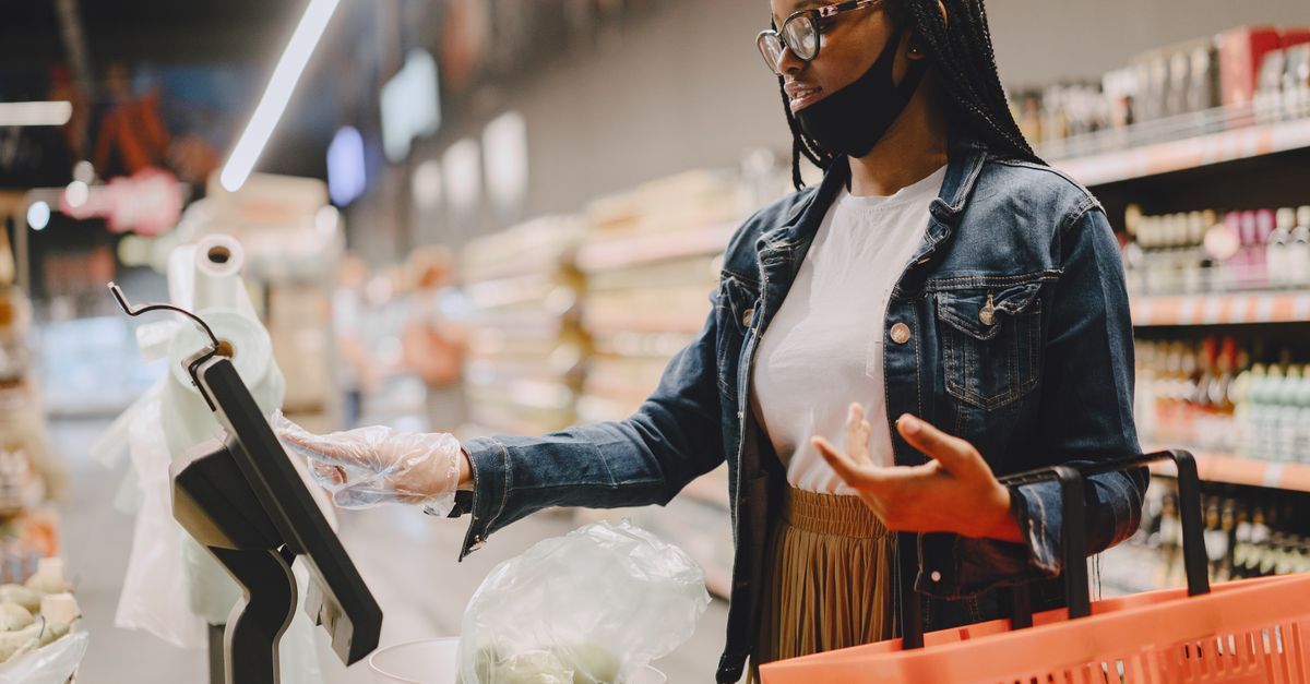 A woman weighing vegetables in a supermarket using a digital scale with a shopping basket. — illustrating make receipt walmart