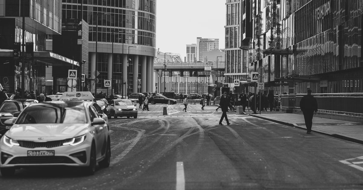 Busy city street scene in Moscow with cars, pedestrians, and modern architecture. — illustrating taxi receipt