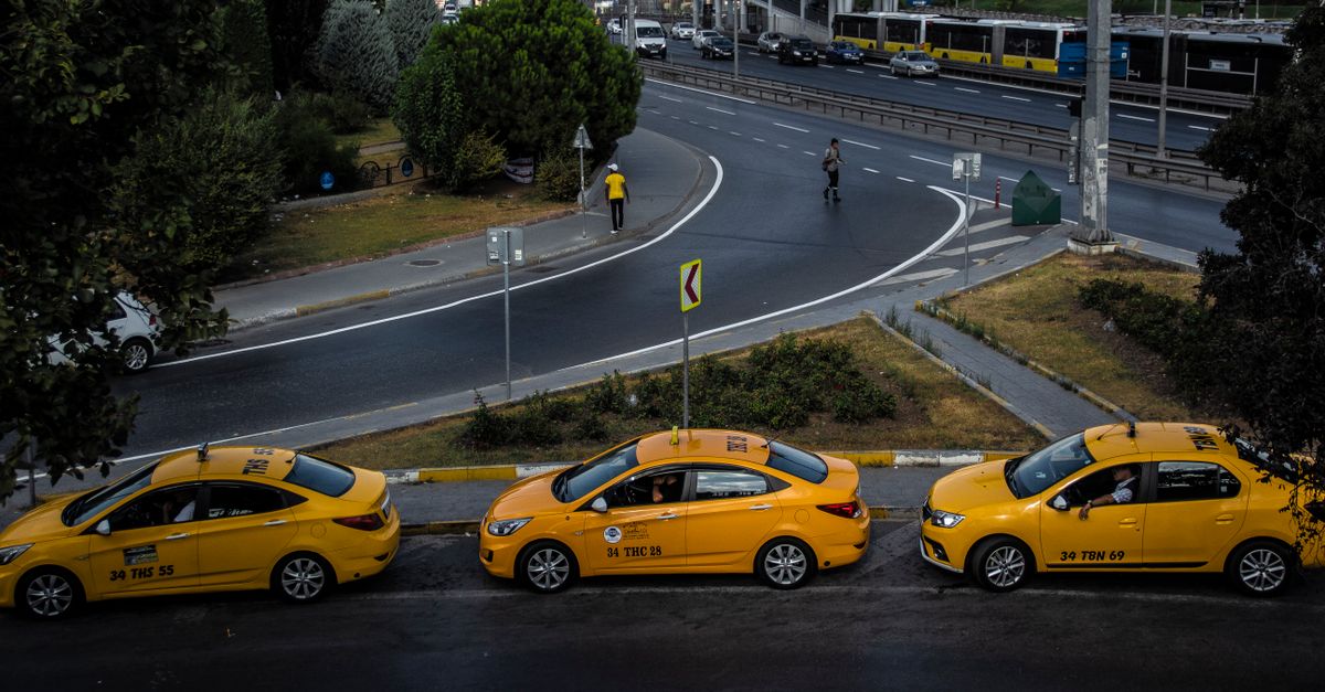 Aerial view of a city street with three yellow taxis and pedestrians crossing. — illustrating taxi receipt