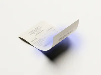A finished receipt curling upward off the surface as it is exported